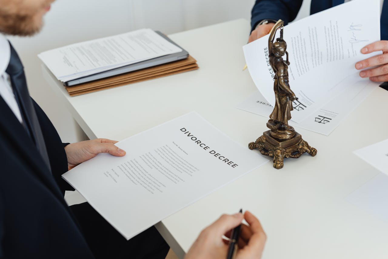 Two professionals discuss divorce decree documents, focusing on legal negotiations.